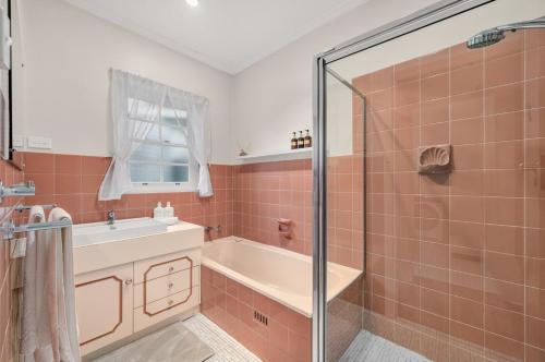 a bathroom with a shower and a tub and a sink at The Retreat, Barossa Valley in Lights Pass