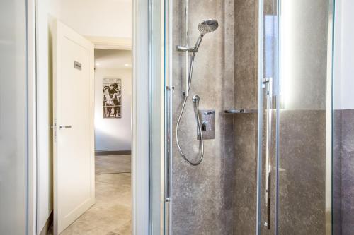 a bathroom with a shower with a glass door at B&B il Barbero in Siena