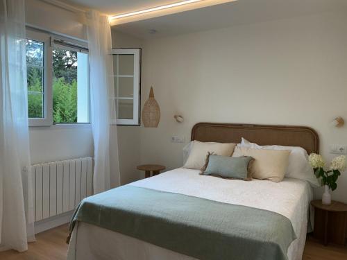 a bedroom with a large bed with a window at Quinta del Mar suites - Costa Quebrada in Soto de la Marina