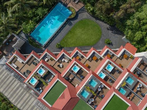 an aerial view of a house with a swimming pool at Grand Mercure Goa Candolim - An Accor Hotels Brand in Candolim
