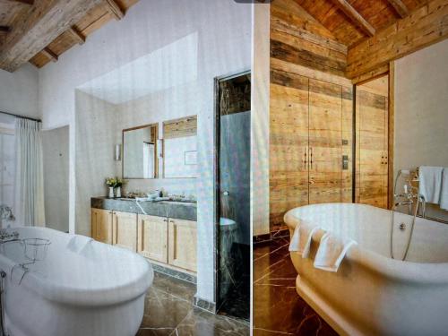 a bathroom with a tub and a sink and a toilet at Valley View Residence in Sankt Anton am Arlberg