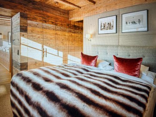 a bedroom with a large bed with red pillows at Valley View Residence in Sankt Anton am Arlberg