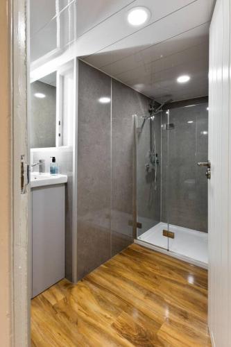 a bathroom with a shower with a glass door at The Tavern in Buchlyvie