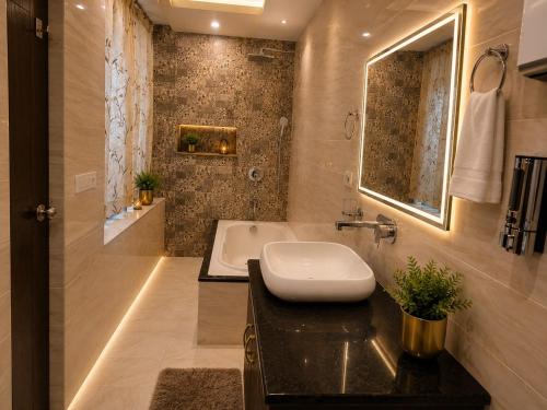 a bathroom with a sink and a bath tub at Castal Blue Hotel Near IGI Delhi Airport - Free Breakfast and Dinner complementry in New Delhi