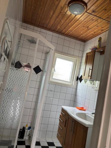 a small bathroom with a sink and a shower at Vila in Hultsfred