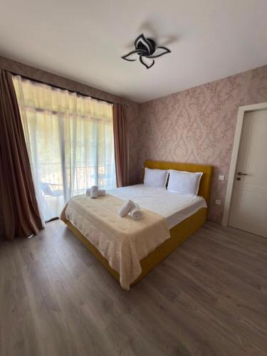 a bedroom with a bed with a ceiling fan at G&G დასასვენებელი სახლი in Tsaghveri