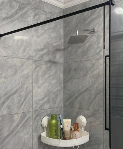 a shower stall with a shelf in a bathroom at Jets Stay Property in Cape Town