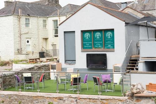 a group of chairs and a table in front of a building at The Birchtree Hotel in Dalbeattie