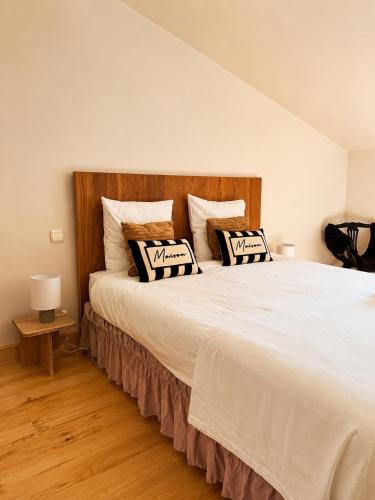 a bedroom with a large white bed with pillows at Villa Harmonie in Monteton