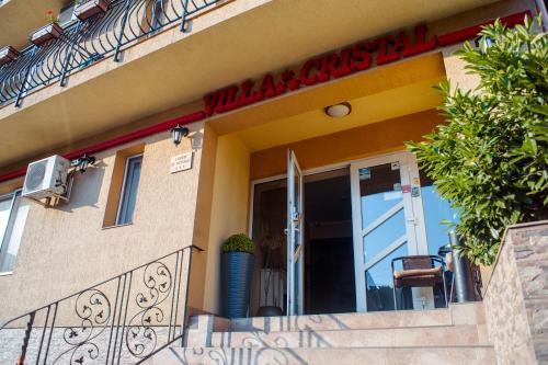 a building with a sign on the side of it at Vila Cristal in Baile Felix