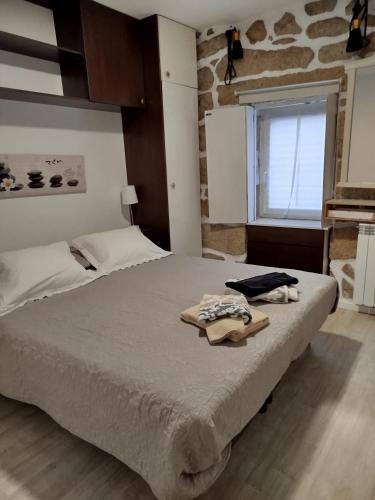 a bedroom with a bed with two towels on it at Casinha de Lamares in Vila Real