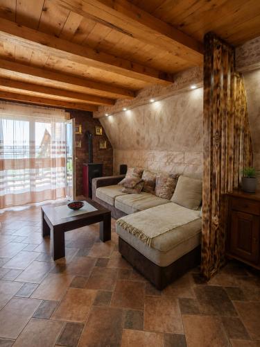 a living room with a couch and a table at Vila Andreoni,na obali Dunava in Kovin
