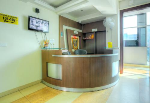 a waiting room with a counter in a hospital at Treebo Trend Shivam Inn near Singapore Mall in Lucknow