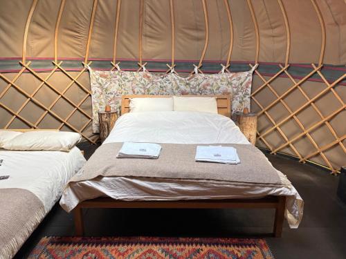 a bedroom with a bed in a yurt at Ash Yurt in Kent