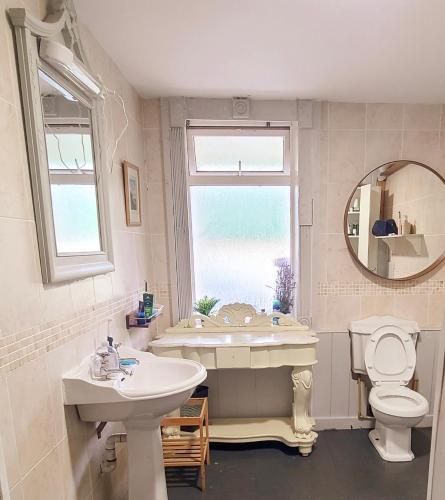 a bathroom with a sink and a tub and a toilet at Iona in Blessington