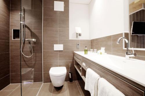 a bathroom with a toilet and a sink and a shower at Schmiede 7 in Beilngries