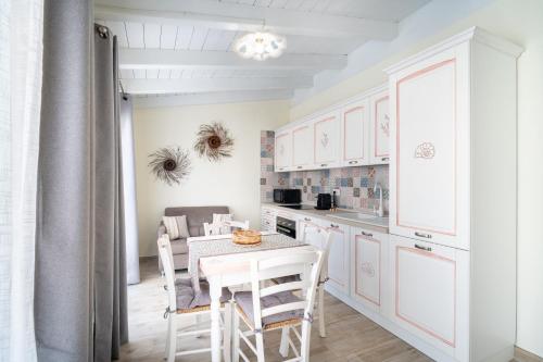 a kitchen with a table and chairs in a room at Su Mari in Villasimius