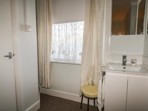 a bathroom with a sink and a window at Sylvian in Bexhill