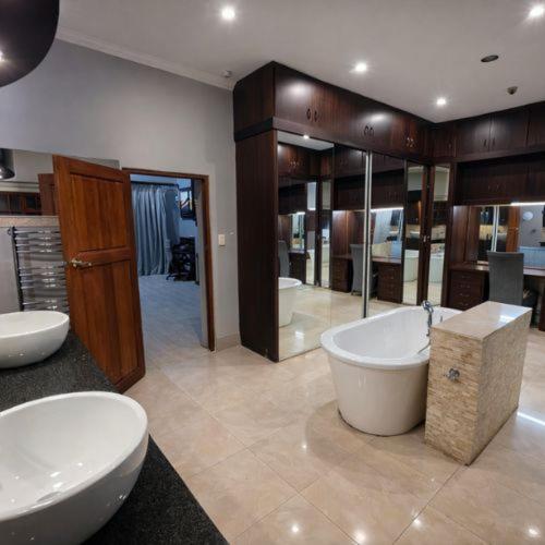 a large bathroom with two sinks and two toilets at Sable Mountain in Hekpoort