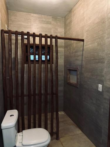 a bathroom with a toilet and a shower at Varanda do Vale in Palmas