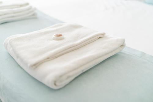 a white towel sitting on top of a table at Porto & Douro Vista Apartments by Inviting in Valbom