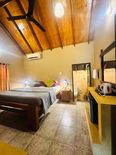 a bedroom with a large bed in a room at My Village in Tissamaharama
