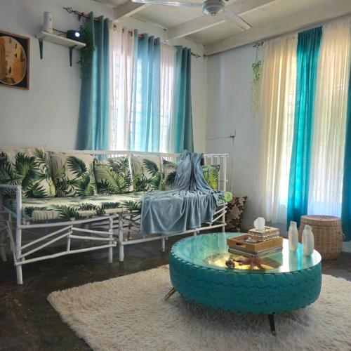 a living room with a couch and a table at Palm Paradise in Diani Beach