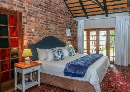 a bedroom with a bed and a brick wall at Crestwood Bed & Breakfast in Curryʼs Post