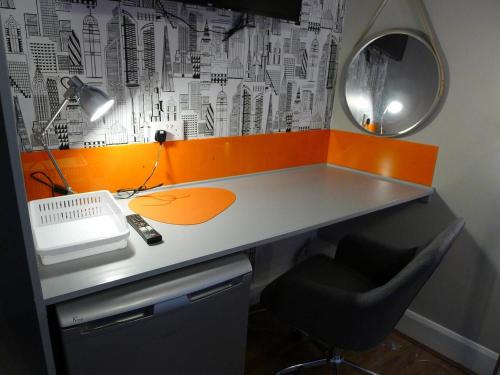a desk with a computer and a chair and a mirror at Saltoun House in Fraserburgh