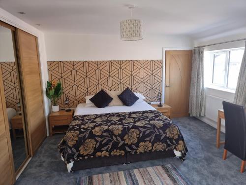 a hotel room with a bed and a window at Exeter Executive Apartments in Pinhoe