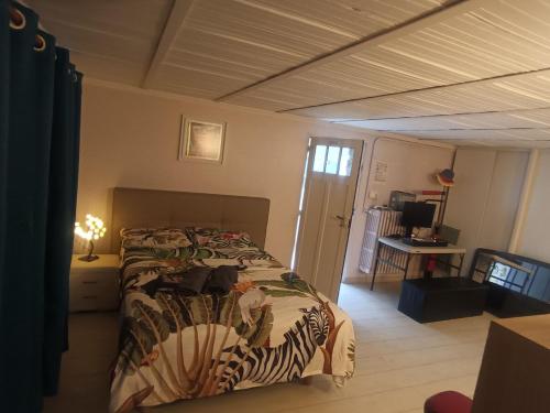 a bedroom with a bed with a comforter on it at Charming House with Private Pool Near Paris - Maison du Bonheur in Gournay-sur-Marne