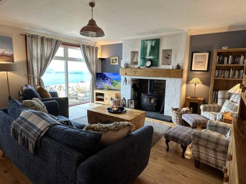 a living room with a couch and a fireplace at Dunhallin Ard in Hallin