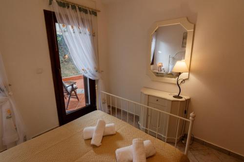 a bathroom with two towels on a bed with a mirror at Villa Lito in Litochoro