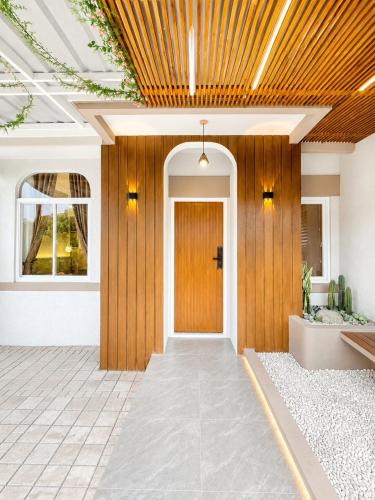 a hallway with a wooden door in a house at Willow House in Padalarang