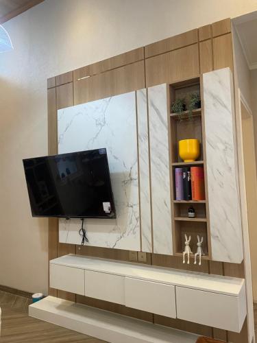 a living room with a tv on a wall at Willow House in Padalarang