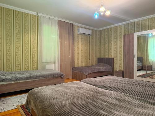 a hotel room with two beds and a mirror at Panoramic apartment in Gabala
