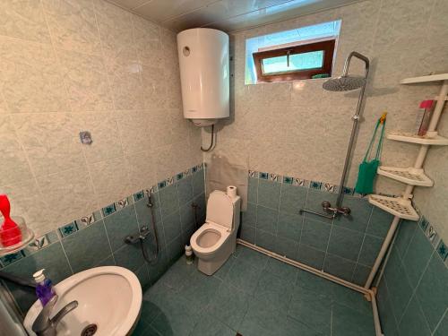 a bathroom with a toilet and a sink at Panoramic apartment in Gabala