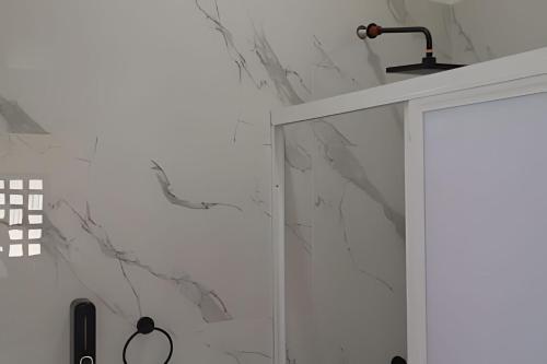 a bathroom with a shower with marble walls at 6-Private Pool and View of Lake Chapala in Chapala