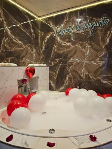 a bathroom with red and white balloons on a counter at Trébol Hotel in Yurimaguas