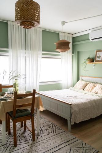 a bedroom with a bed and a table and a window at Dotan's Boutique Studios - By The Beach! in Tel Aviv