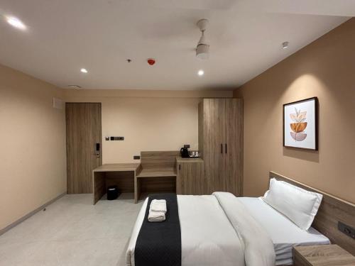 a bedroom with a bed and a desk in it at Rivotel The Luxury Hotel in Chākan