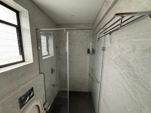 a shower with a glass door in a bathroom at Rivotel The Luxury Hotel in Chākan