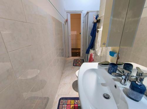 a bathroom with a sink and a shower at Pineta Holiday Home in Genoa