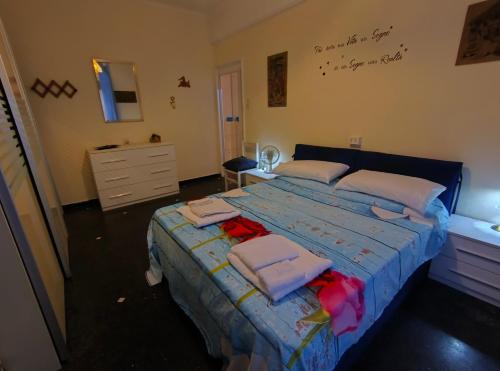 a bedroom with a bed with towels on it at Pineta Holiday Home in Genoa