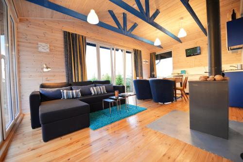 a living room with a couch and a table at Kliukai in Dubingiai