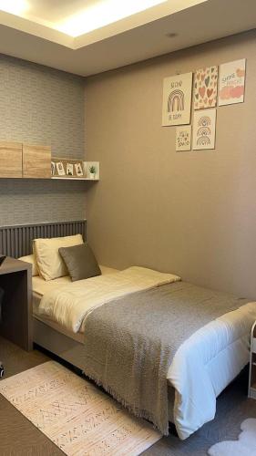 a bedroom with a large bed in a room at Ivory House in Gantungan