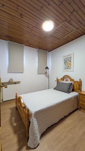 a bedroom with a large bed in a room at Casa da Cerca in Cenlle