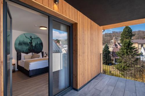 a bedroom with a bed on a balcony at Resort Aurum in Černý Dŭl