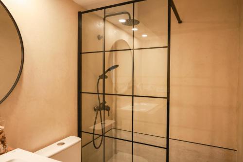 a glass shower in a bathroom with a toilet at Apartaments Bellreguard in Papiol