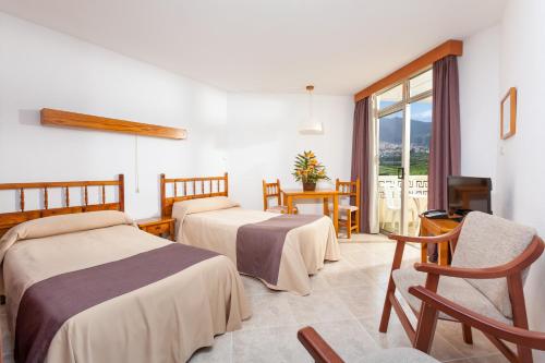 Postel nebo postele na pokoji v ubytování Hotel Panoramica Garden